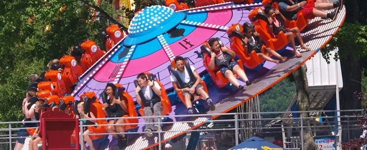 People spinning on a high thrill ride